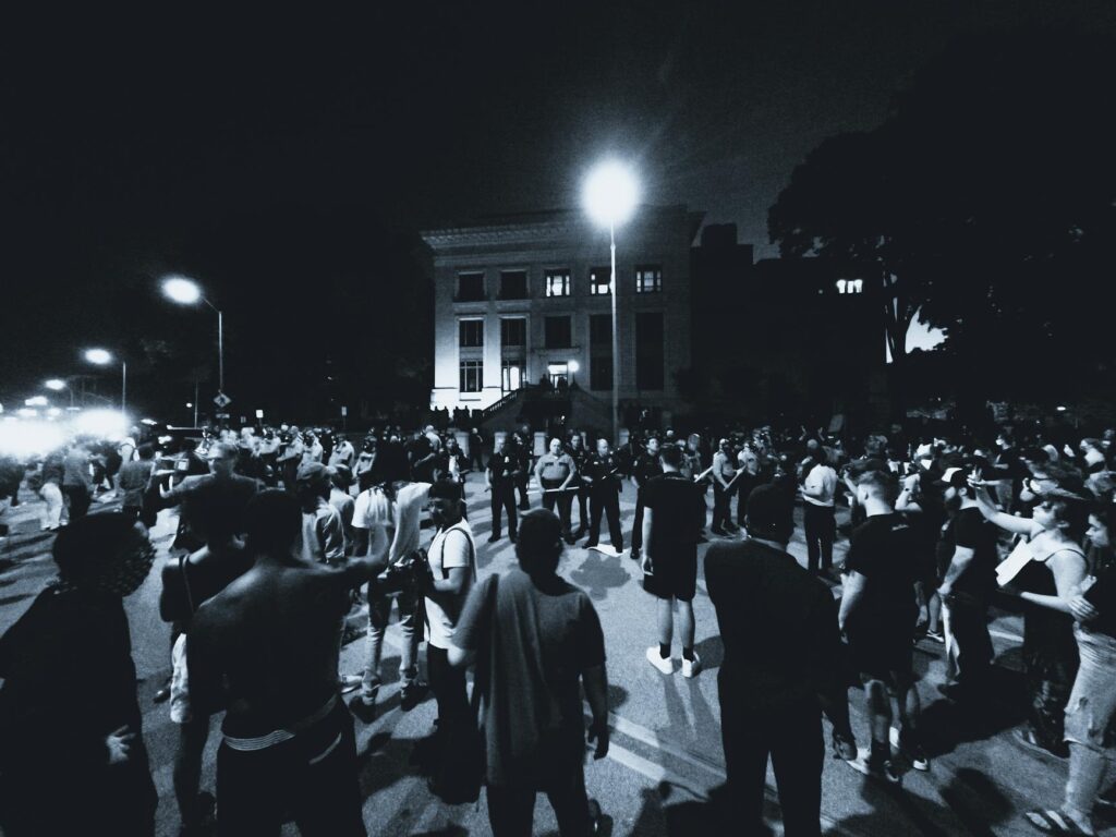 grayscale photo of protesters on a street