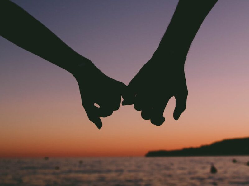 two person holding pinkies