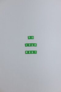 green scrabble tiles on a white surface