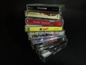 Stack of collection cassettes tape from the 1990's until 2000's isolated on a black background