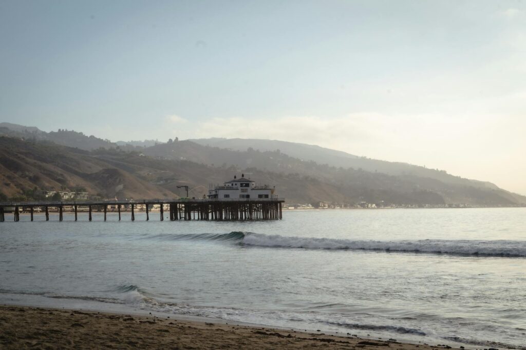 building at end of pier by sea shore