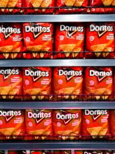 rows of doritos on shelf in brazilian store