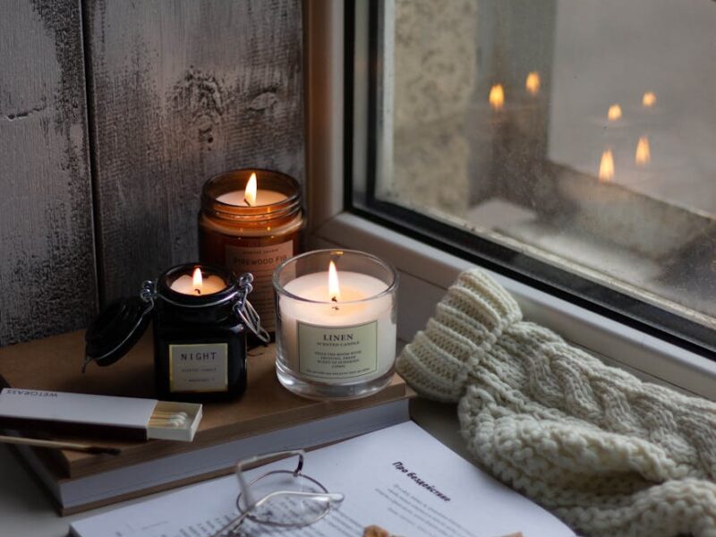 a lighted candles by the window
