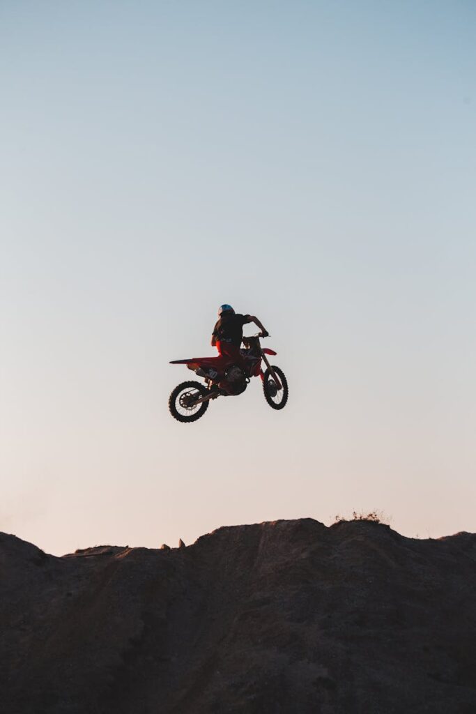 a person on a motorcycle above a hill