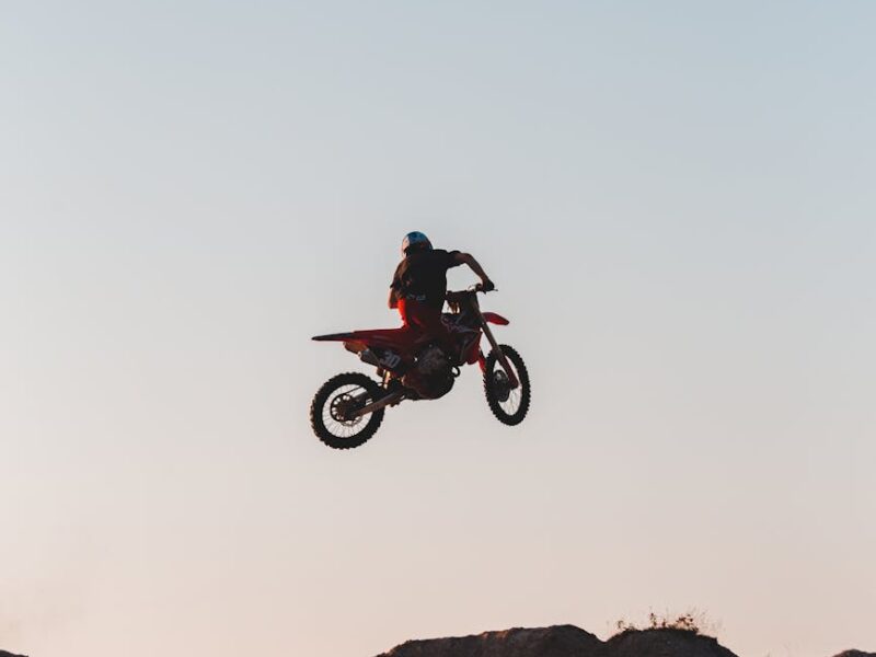 a person on a motorcycle above a hill