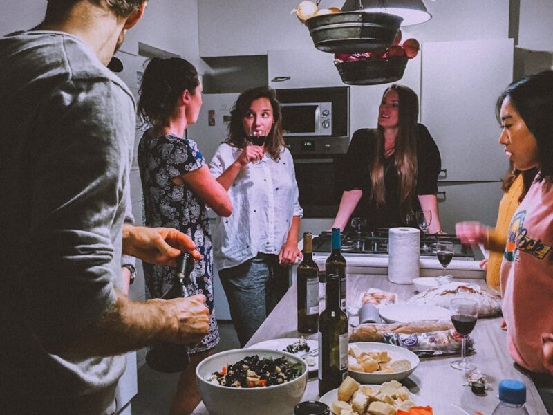 men and women standing infront of dining table