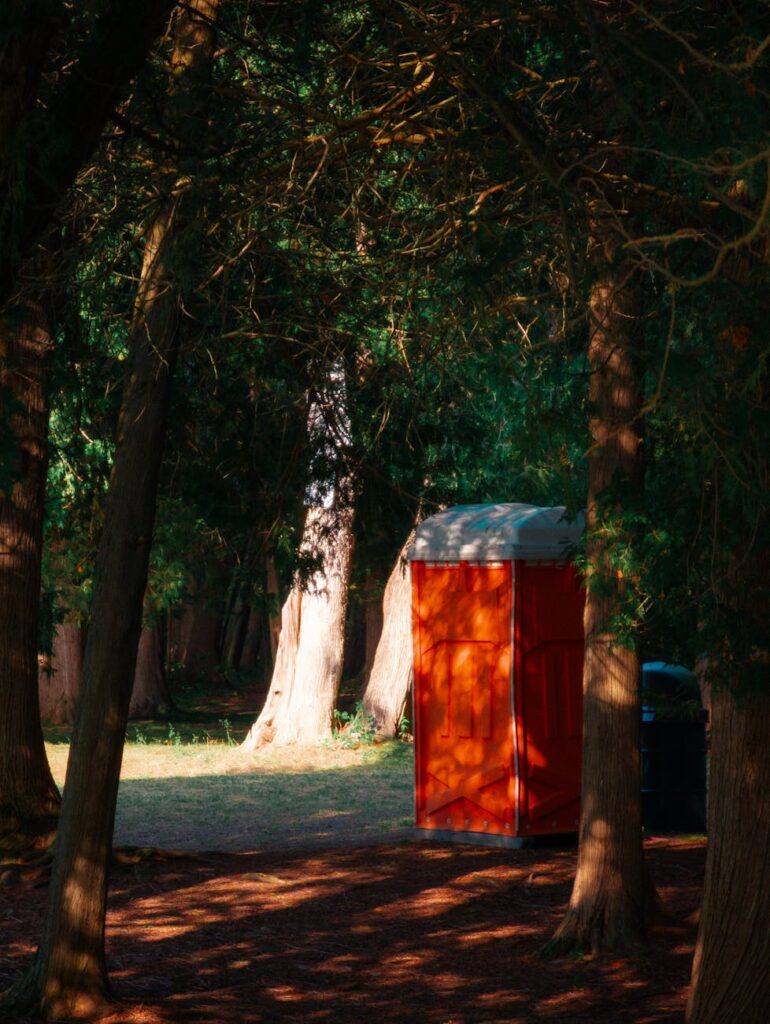 orange portable toilet in davidsons beach forest