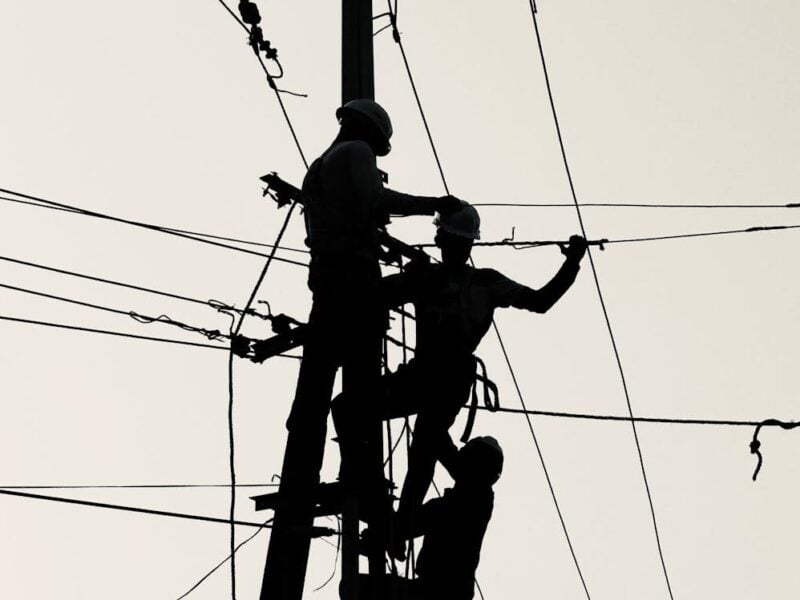 utility workers silhouette repairing power lines