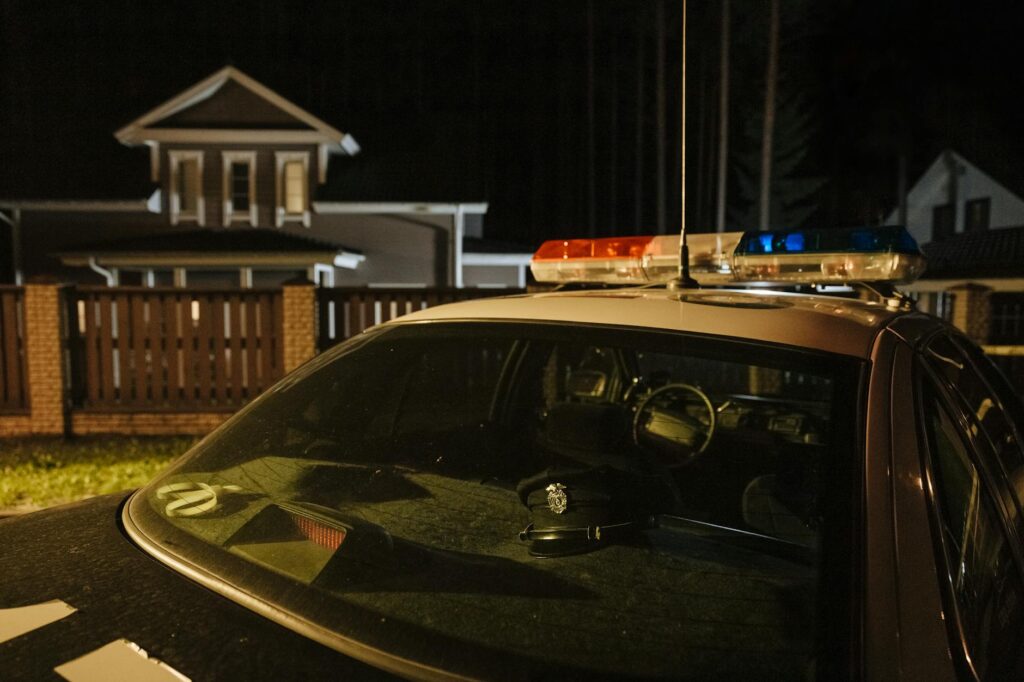 police car parked outside a house