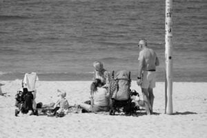 family relaxation at the beach in black and white