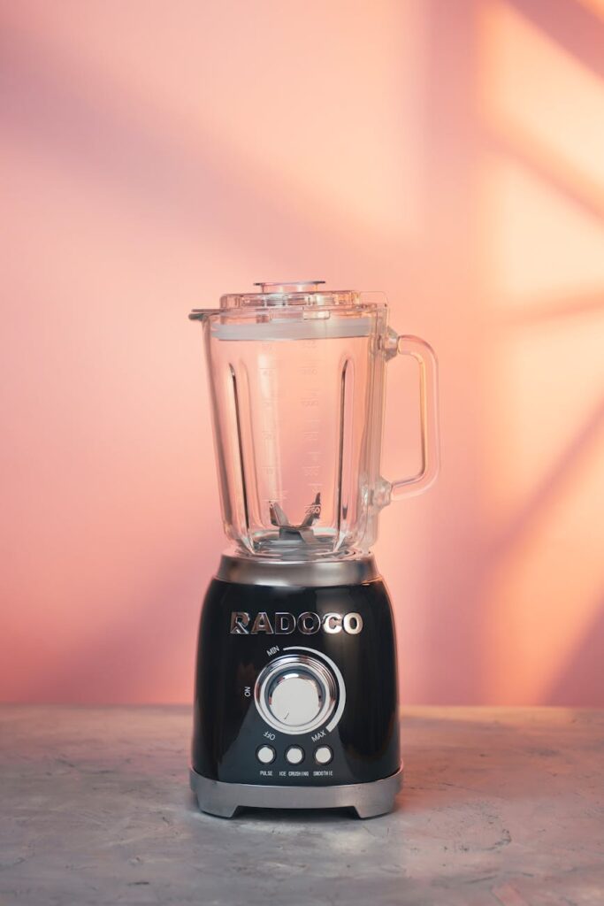 stylish blender against pink wall