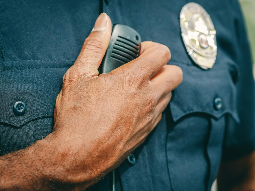 a police office holding black radio
