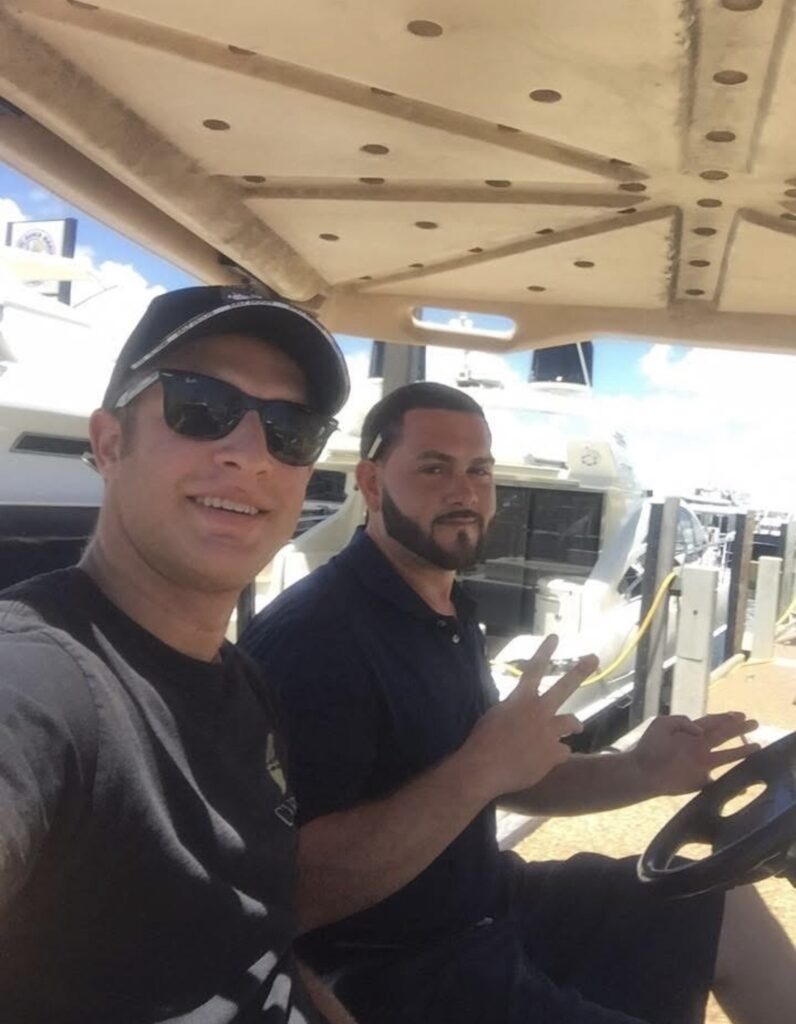 Kasdyn Click with Giovanni Braccio driving a marina operations golf cart at Miami Beach Marina, January 2014