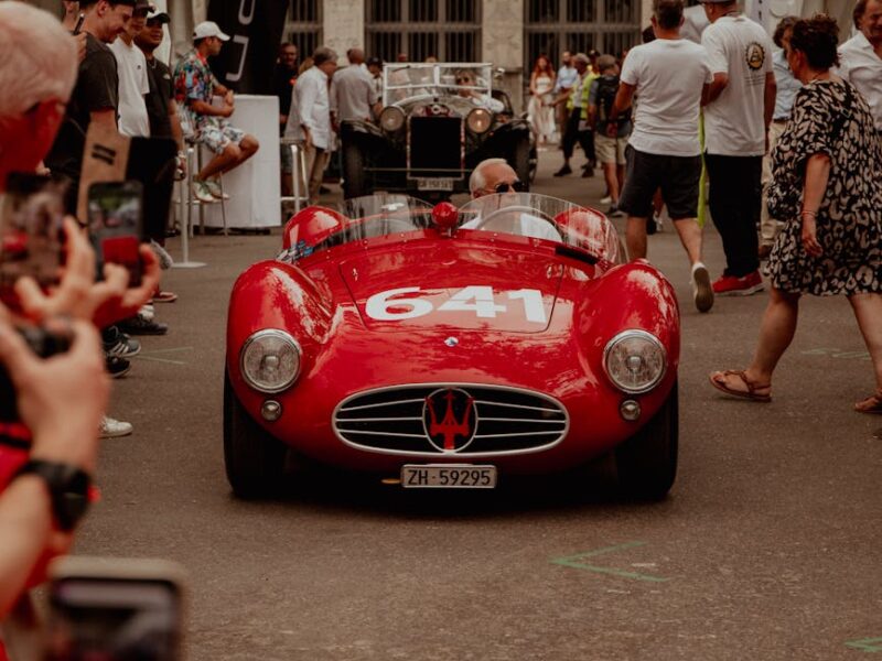 a red sports car is parked on a red carpet