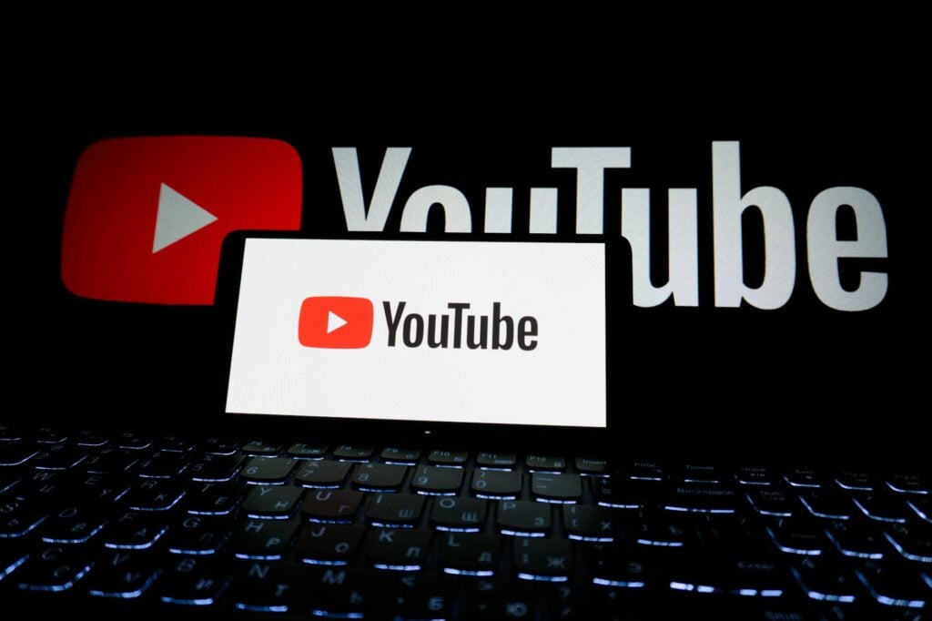 youtube logo on laptop screen in dark setting