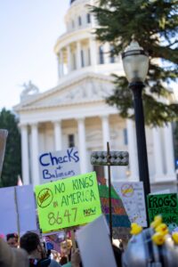 protest at sacramento capitol with signs and crowd