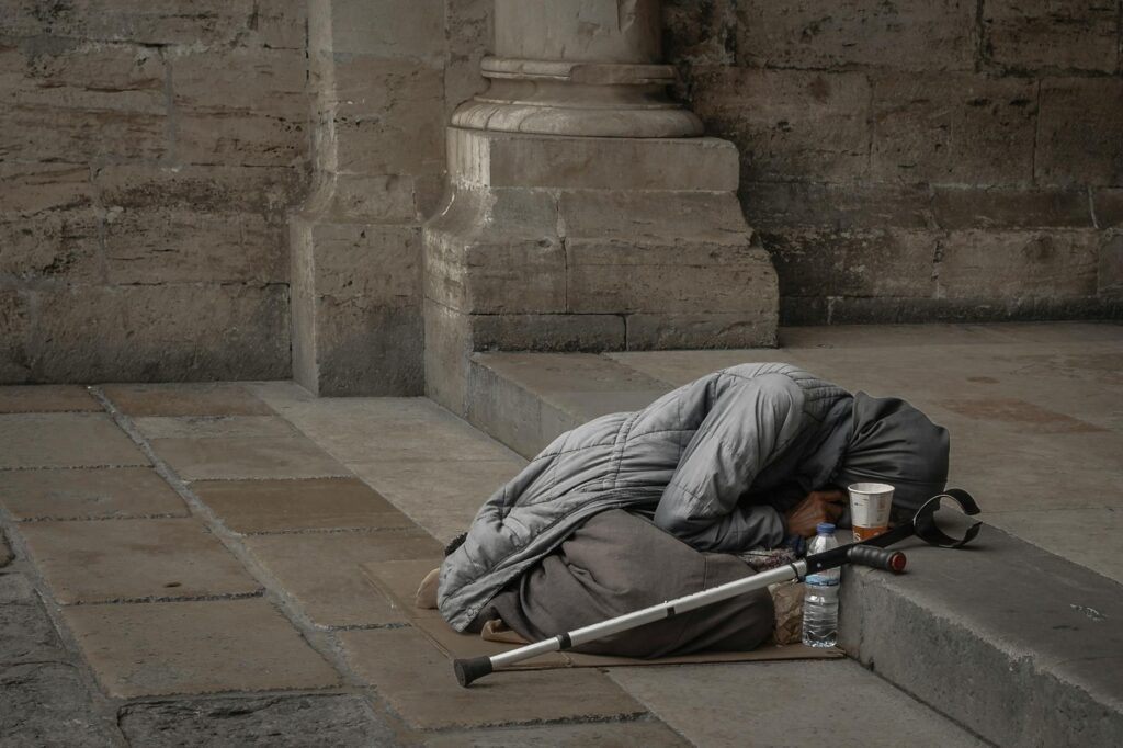 a beggar lying on the floor