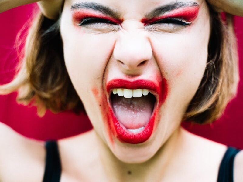 woman in red makeup screaming