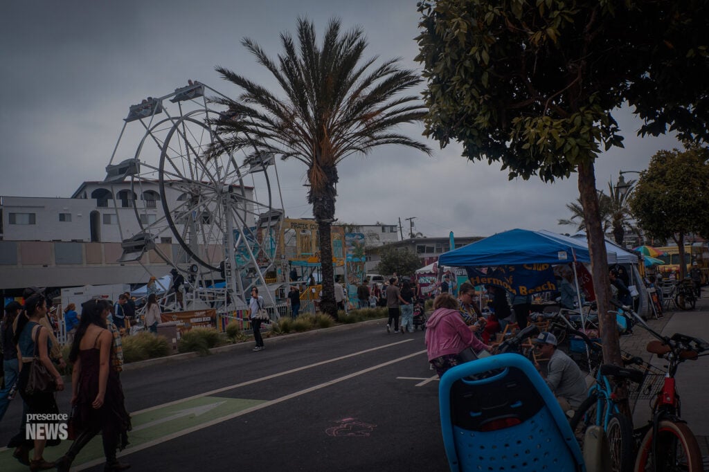 Visitors walk through the Fiesta Hermosa fairgrounds featuring rides, attractions, and vendor booths near the beach during Memorial Day weekend. (Photo by Maria Cornejo / Presence News)