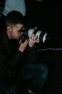 man photographing with telephoto lens