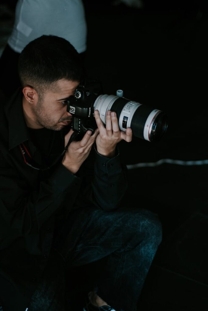man photographing with telephoto lens