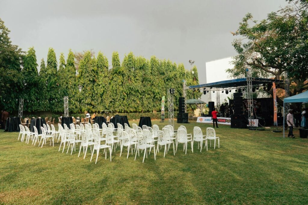 outdoor event setup with empty chairs and stage