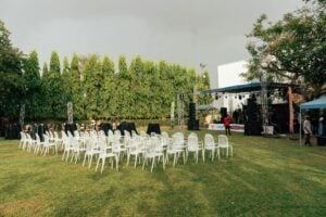 outdoor event setup with empty chairs and stage
