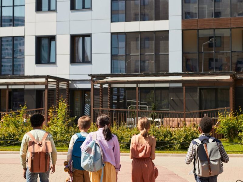 people walking towards the concrete building