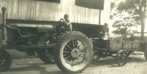 Ellington, CT, USA, Summer of 1928: Fred driving 1928 Farmall tractor, Martin is sitting on the wagon
