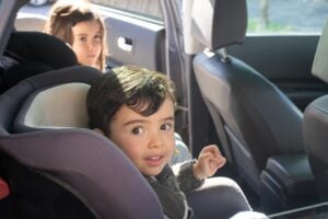 boy sitting on car seat