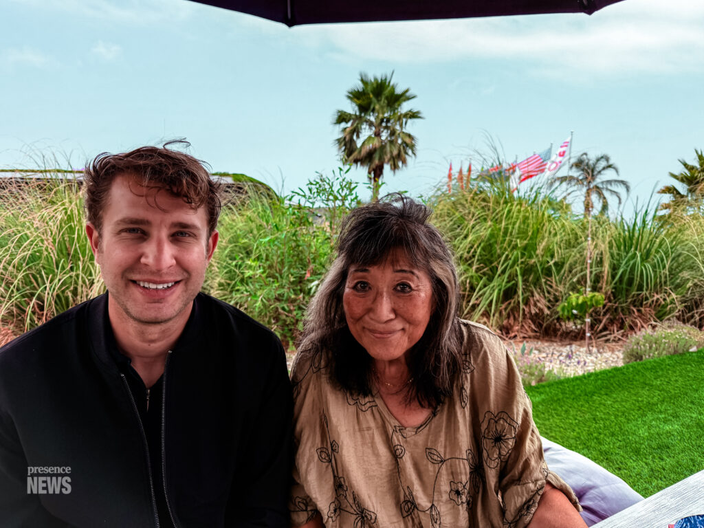 Malibu, CA, USA, June 2026: Kasdyn from Presence News in the hills of Malibu talking with locals on residential property under construction to rebuild.