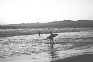 black and white surfer surfing