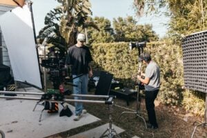 outdoor film set with camera crew and equipment