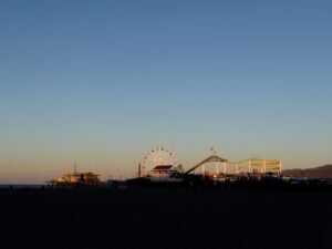 amusement park on beach in shadow at sunset