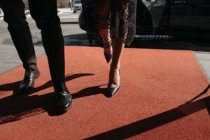 a couple standing on the red carpet